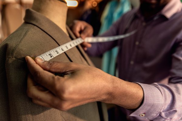 close-up-of-male-fashion-tailor-hand-working-on-th-TFXWDRZ